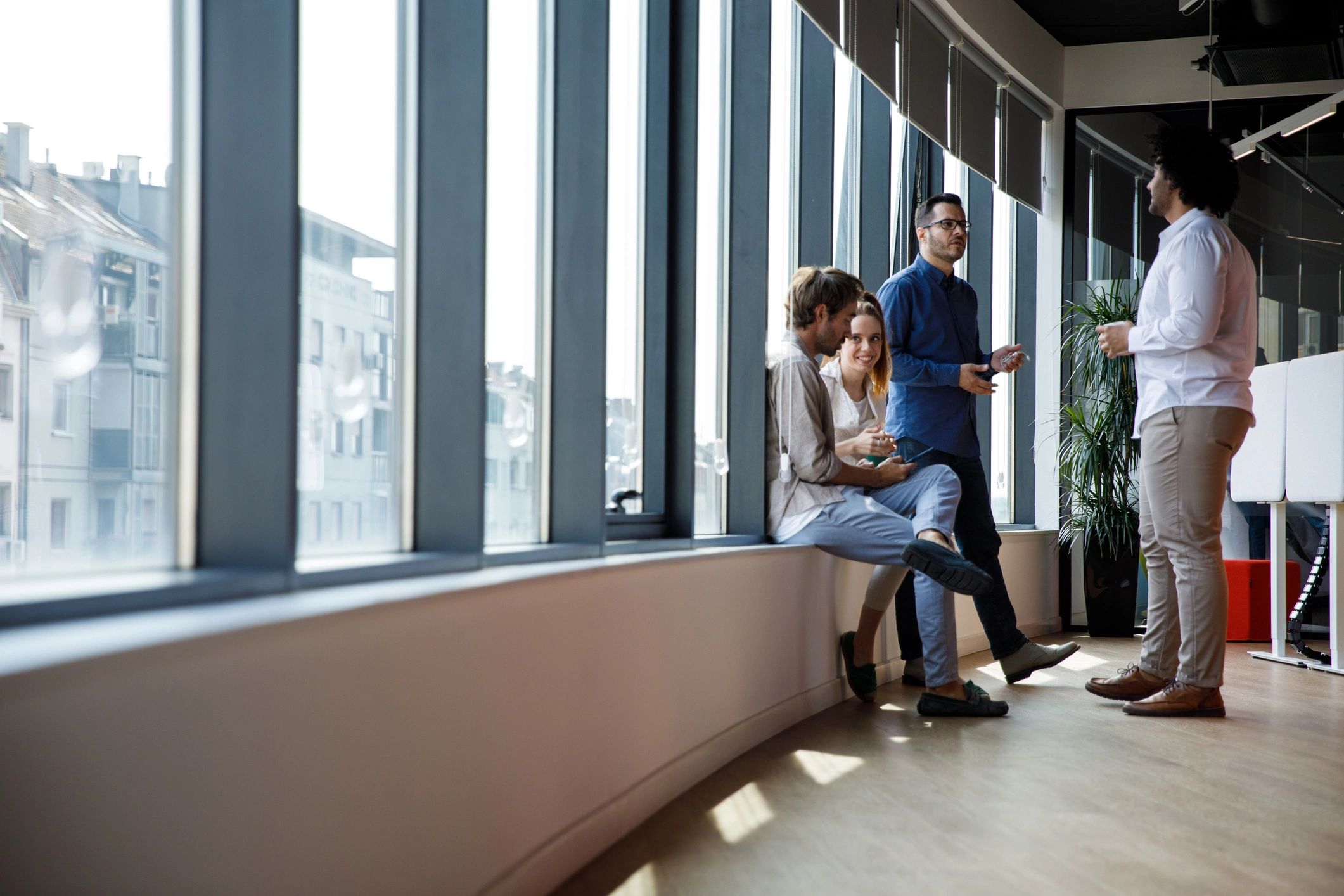 Business colleagues chatting casually during coffee break