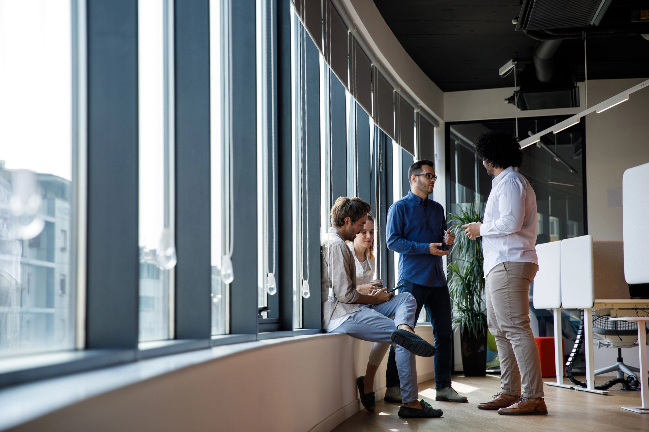 Group of business people in office lobby during work break